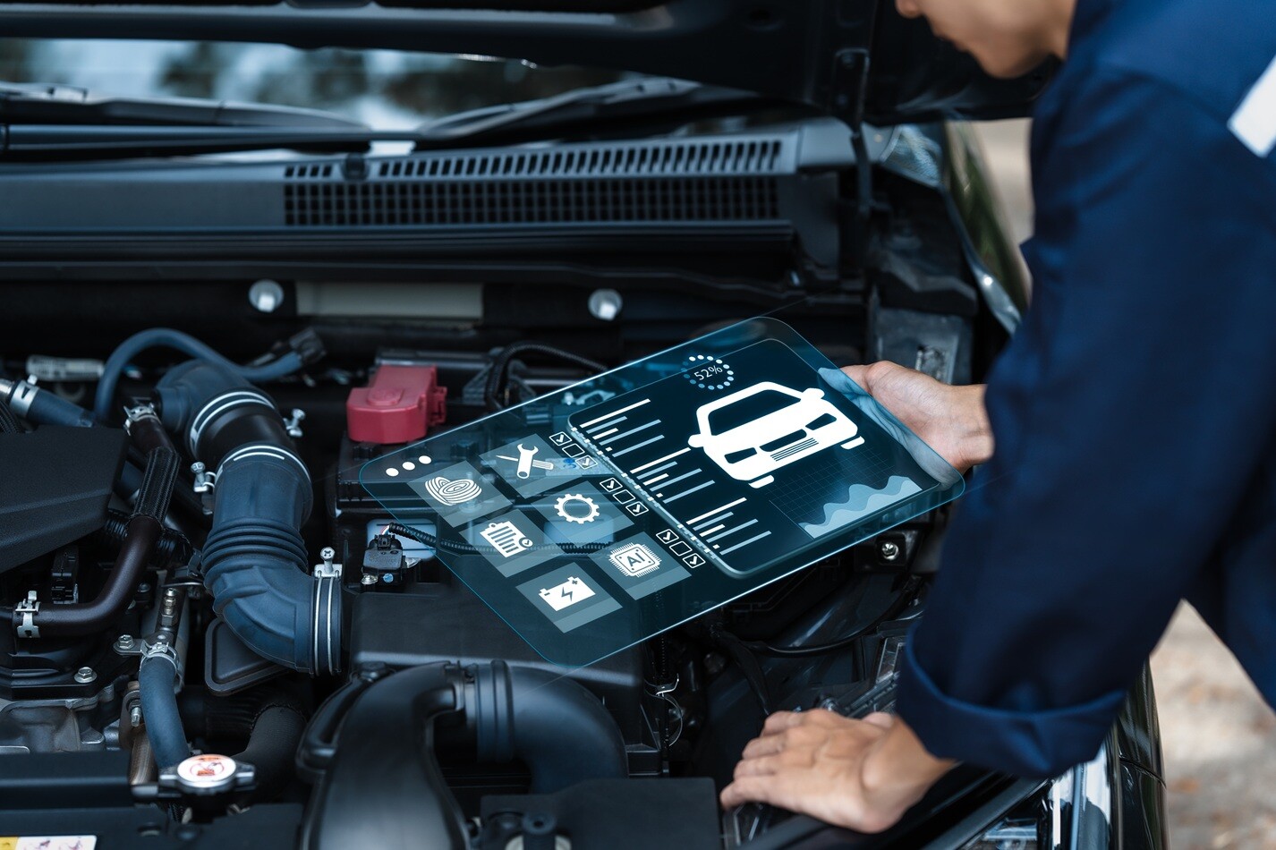 A technician working on automotive electronics with precision tools